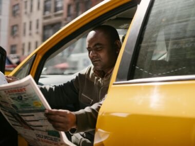 A taxi driver in Australia reading paper